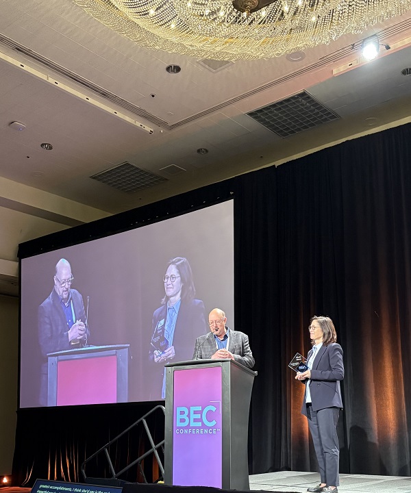 Rick Locke presents Leadership Award to Nicole Harris during BEC Conference