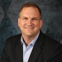 headshot photo of smiling Chris Beard