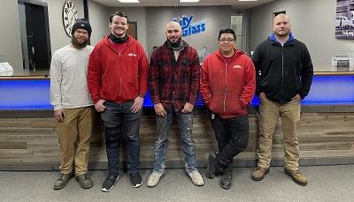 five male apprentices smiling